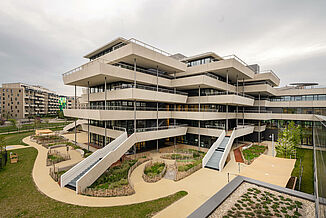 Part of the Aaron Mencer Campus in Vienna with surrounding terraces and gardens.